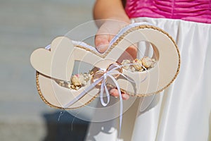 Wedding rings of the bride and groom on a handmade board. Beautiful wedding decoration. Soft focus