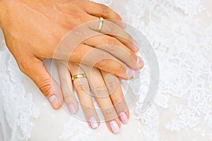 The wedding rings on bride and groom hands.  Newly married couple hands
