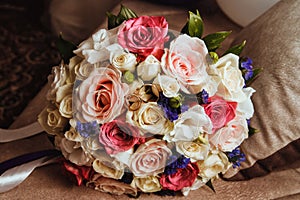 Wedding rings on the bride`s bouquet. Beautiful bride`s bouquet with roses