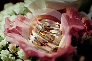 Wedding rings close-up lie on the wedding bouquet of flowers