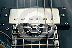 Wedding rings on the cords of the guitar