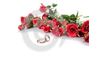 The wedding rings and flowers on white background