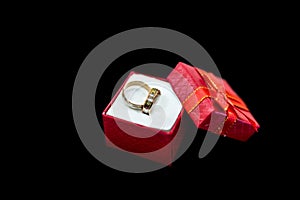Wedding rings in gift box isolated on black