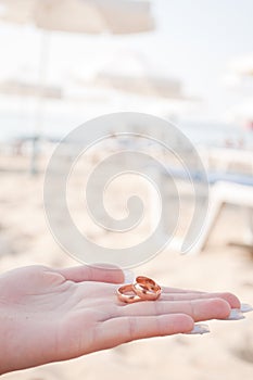 Wedding rings in the hands of women photo