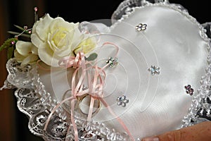 Wedding rings on heart pillow