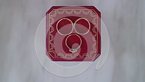 Wedding rings jewelry. Three gold rings on red box.