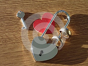 Wedding rings, key, lock and red heart