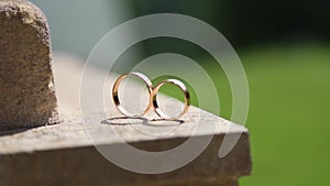Wedding rings lie on the stone floor