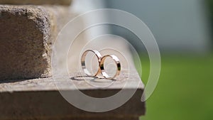 Wedding rings lie on the stone floor