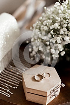 Wedding rings lie on a wooden box