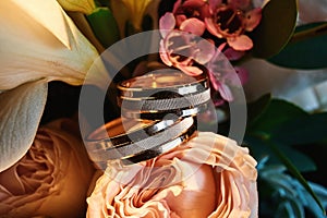 Wedding rings made of gold on a bouquet of flowers