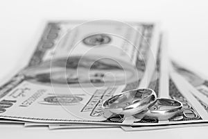 Wedding rings and money on a white background photo