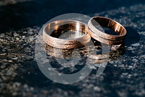 Wedding rings for newlyweds on a dark background