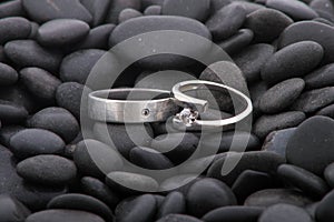 Wedding rings on pebbles