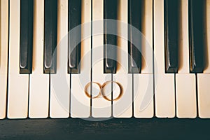 Wedding rings on a piano