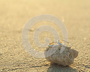 Wedding rings put on the beach.