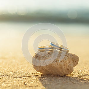 Wedding rings put on the beach.