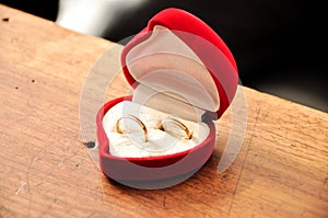 Wedding rings in a red heart shaped box