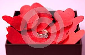 Wedding rings on the red hearts. Pink background. The concept of betrothal, divorce, parting, infidelity .Selective focus