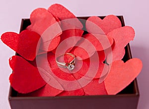 Wedding rings on the red hearts. Pink background. The concept of betrothal, divorce, parting, infidelity .Selective focus