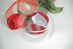 Wedding rings and red rose on white background.photo with copy space