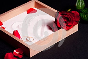 Wedding rings and red roses