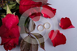Wedding rings and red roses