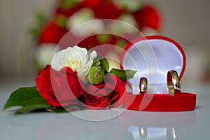 Wedding rings, red roses