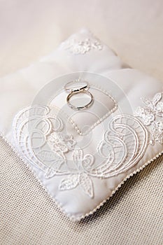 Wedding rings on ring barer pillow
