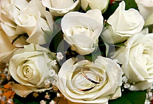 Wedding rings in rose bouquet