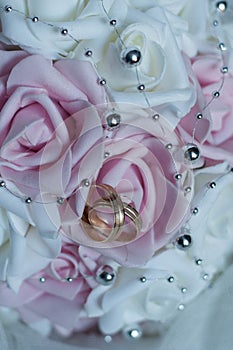 Wedding rings on roses