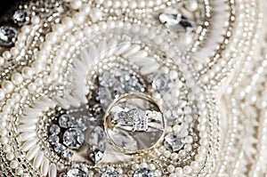 Wedding rings on sequins and pearls
