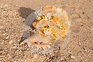 Wedding rings in a shell on the beach