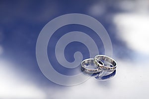 Wedding rings on a shiny surface