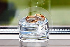 Wedding rings on sparkling piece of ice