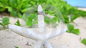 Wedding rings and startfish beach love concept