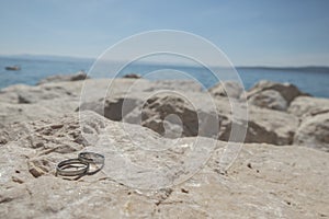 Wedding rings on a stone cliff