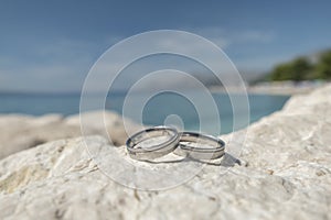 Wedding rings on a stone cliff