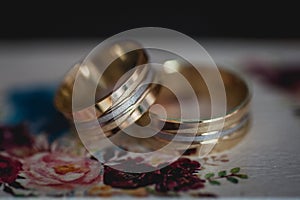 Wedding rings on top of a colorful wedding ring box