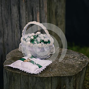 Wedding rings on top of white and green pillow