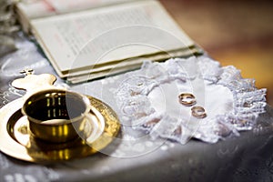 wedding rings on a wedding ceremony in the church, wedding ceremony, glans photo