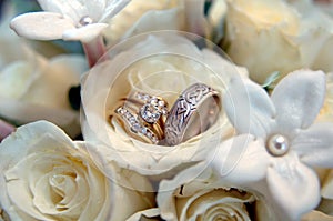 Wedding rings in white flowers photo