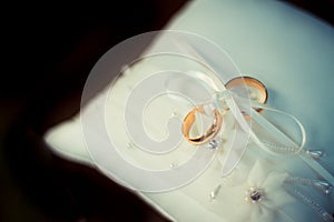 Wedding rings on a white pillow