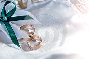 Wedding rings on a white tray with a bow. Preparing for the wedding