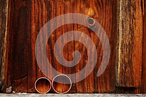 Wedding rings on wooden background. Love concept of marriage.