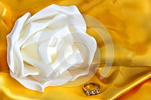 Wedding rings on yellow fabric