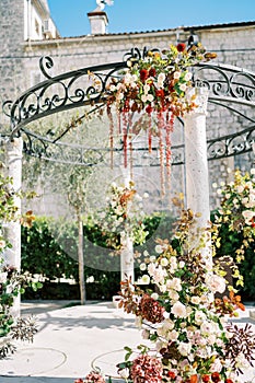 Wedding rotunda decorated with flowers near an ancient house