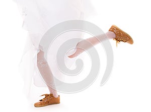 Wedding. Running bride woman legs in sport shoes