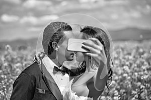Wedding selfie. wedding couple kiss in field yellow flowers