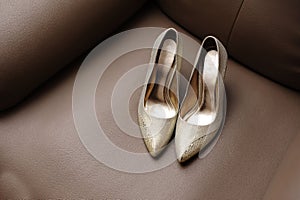 Wedding shoe on brown sofa